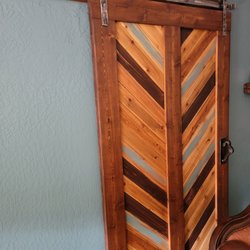 Base Camp Designs - Custom barn door and track. With stain and paint to match walls and trim