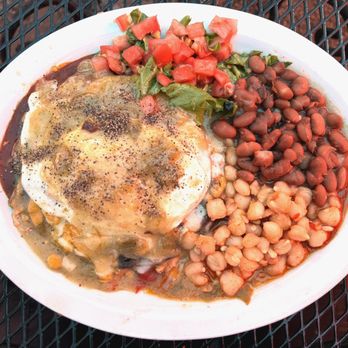 Orlando's New Mexican Cafe - Orlando's. The blue corn chicken enchiladas with an over medium egg, posole and beans. - New Mexican Cuisine Near Me - Taos, New Mexico Orlando's New Mexican Cafe - Orlando's. The blue corn chicken enchiladas with an over medium egg, posole and beans. - New Mexican Cuisine Near Me - Taos, New Mexico