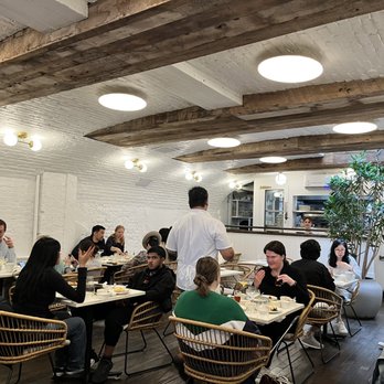 Rana Fifteen - a group of people eating in a restaurant - Mediterranean Near Me - Brooklyn, New York