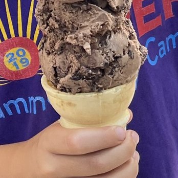 Beacon & Bridge Market - a woman holding a cone of ice cream - Convenience Stores Near Me - Gladwin, Michigan