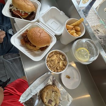 Rosie's Burgers - The spread. The Rosie, Spicy chicken sando, fries, lemonade, banana pudding and chocolate chip cookie. - Burgers Near Me - Mississauga, Ontario Rosie's Burgers - The spread. The Rosie, Spicy chicken sando, fries, lemonade, banana pudding and chocolate chip cookie. - Burgers Near Me - Mississauga, Ontario