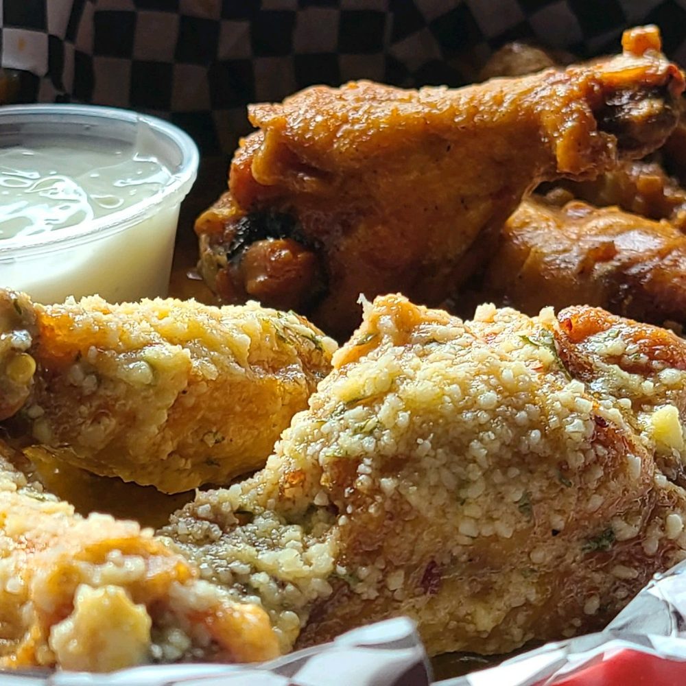 a basket of fried chicken with a side of ranch dressing a basket of fried chicken with a side of ranch dressing