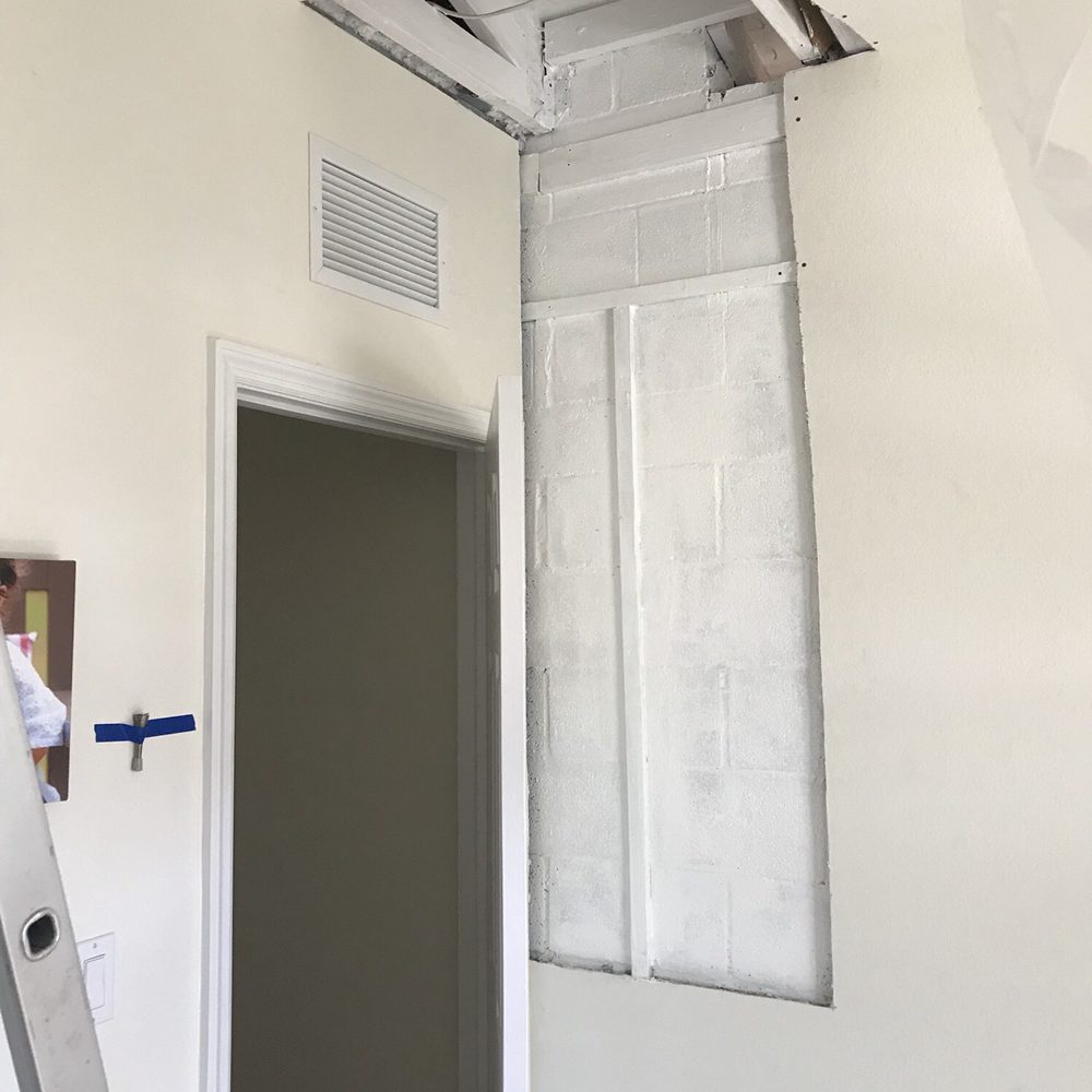 Decon Environmental - a man standing on a ladder in a room - General Contractors Near Me Decon Environmental - a man standing on a ladder in a room - General Contractors Near Me