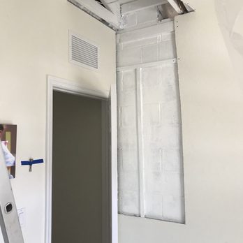 Decon Environmental - a man standing on a ladder in a room - General Contractors Near Me Decon Environmental - a man standing on a ladder in a room - General Contractors Near Me