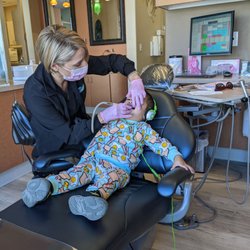 Pediatric Dental Specialists of El Dorado Hills - Kid friendly staff and chair.. headphones for the TV in the ceiling while they're laying down.