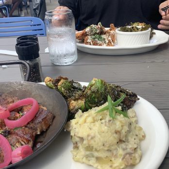 Tupelo Honey Southern Kitchen & Bar - Fried chicken and pork shoulder dinners. Brussels are delicious! - Southern Near Me - Myrtle Beach, South Carolina