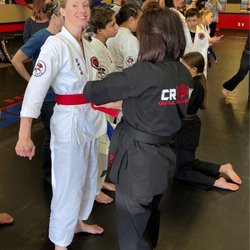 Castle Rock Martial Arts - March 2022. My girl Tracy wrapping me up in my first degree red belt on testing day.