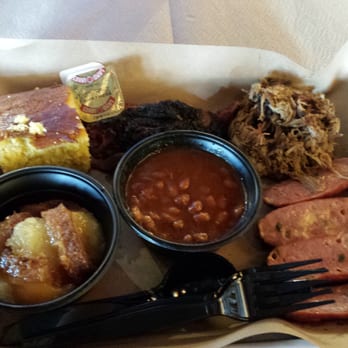 Mission BBQ - 3 meat sampler with moist brisket, pulled pork, and jalapeño and cheddar sausage. Sides of peach cobbler and baked beans - Barbeque Near Me - Richmond, Virginia