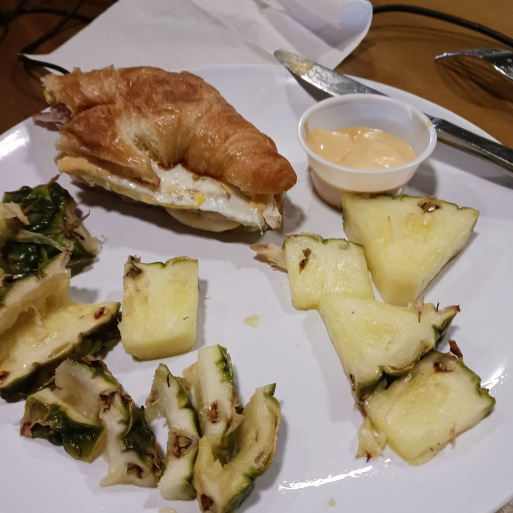 Delicious ham, Swiss and gouda with Sriracha aoli and pineapple on side. Delicious ham, Swiss and gouda with Sriracha aoli and pineapple on side.