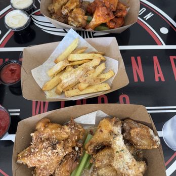 Revolutionary Wings - Bottom left: Chili Pineapple Coconut Bottom right: Butter Garlic Parmesan - Chicken Wings Near Me - San Antonio, Texas Revolutionary Wings - Bottom left: Chili Pineapple Coconut Bottom right: Butter Garlic Parmesan - Chicken Wings Near Me - San Antonio, Texas