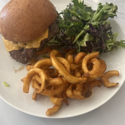 Smash burger with split curly fries and salad
