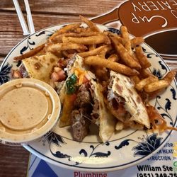 The quesadilla burger with seasoned fries.