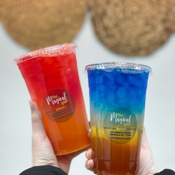 The Magical Spot - a hand holding two drinks - Juice Bars & Smoothies Near Me - Mineola, New York The Magical Spot - a hand holding two drinks - Juice Bars & Smoothies Near Me - Mineola, New York
