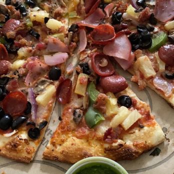 Pieology Pizzeria Southbay Pavillion Mall - There is a thin crust pizza with pineapple, green peppers, pepperoni, olives, ham, red sauce, and garlic sauce. Pesto sauce on the side. - Pizza Near Me - Carson, California