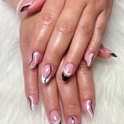 StarNailsBar - This nail set features a soft pink base with elegant black-and-white curved accents,