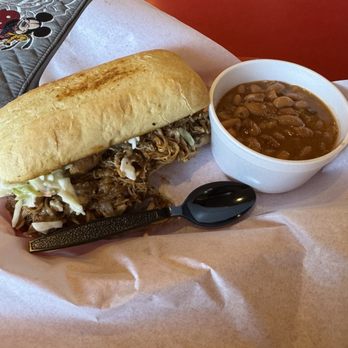 The Pig BBQ & Pub - Pulled pork sandwich with coleslaw and a side of beans. - Barbeque Near Me - Winnemucca, Nevada