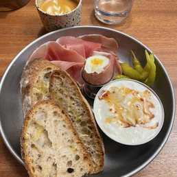 Straciatella with honey, sourdough, cured meats, egg, and sports peppers