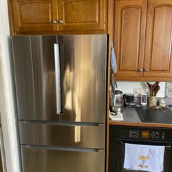 Giles Woodworks - New cabinet above fridge matching 30-year old other cabinets.