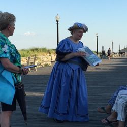 Tiny Tours of Ocean Grove - A guide in Victorian costume shares photos with guests on our walking tour, "Play By the Rules: Fun & Leisure in Early Ocean Grove"