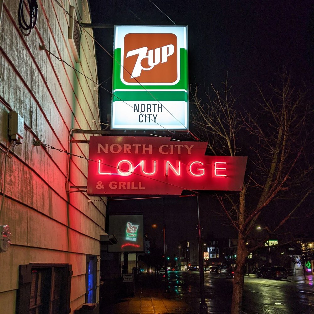 a neon sign for a lounge and grill