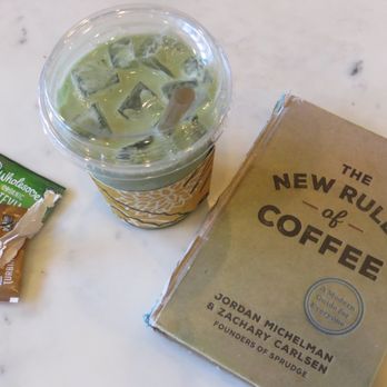 Succulent Coffee Roasters - iced matcha latte (with their coffee book beside it) - Coffee & Tea Near Me - Laguna Beach, California