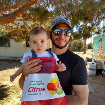 Justice Brothers U-Pick - a man holding a baby - Farmers Market Near Me - Surprise, Arizona Justice Brothers U-Pick - a man holding a baby - Farmers Market Near Me - Surprise, Arizona