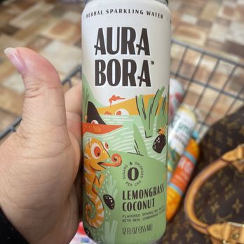 The Market - a person holding a can of aura bora - Grocery Near Me - Flatonia, Texas