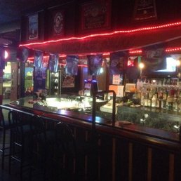 a bar with neon lights and bar stools a bar with neon lights and bar stools