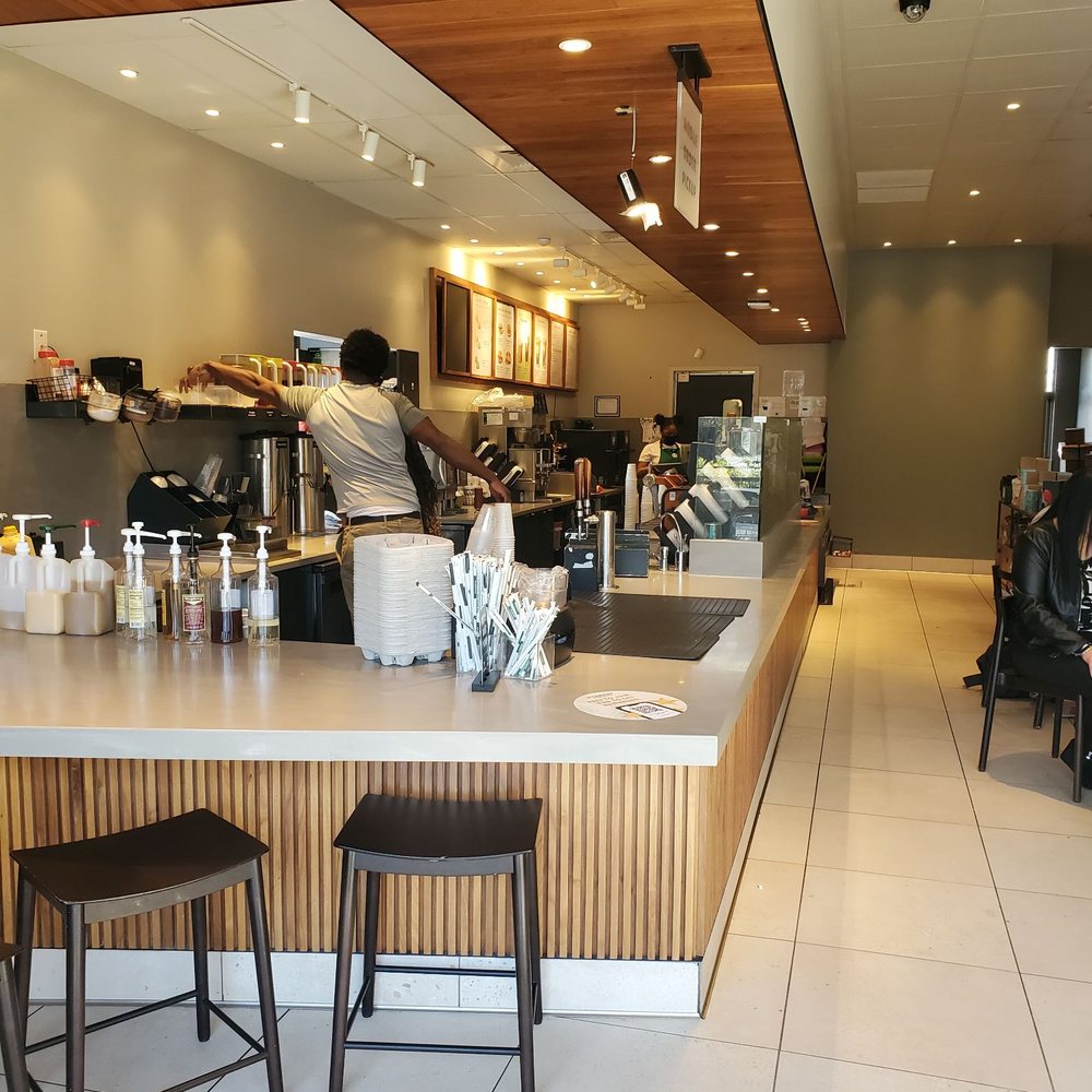 a coffee shop with a counter and stools a coffee shop with a counter and stools