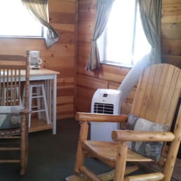 Rustic rocking chairs inside the cabin, AC unit for the hot days and the gas fireplace for the cool nights.