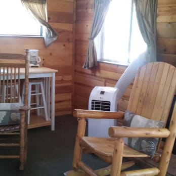 Mountain Meadows Cabins - Rustic rocking chairs inside the cabin, AC unit for the hot days and the gas fireplace for the cool nights. - Hotels Near Me - Payson, Arizona