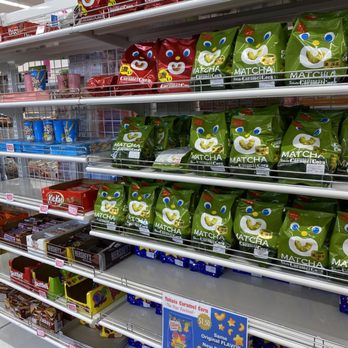 Daiso - Store shelves hold different snack products, including matcha-flavored and caramel corn varieties, with price tags visible. - Department Stores Near Me - Austin, Texas
