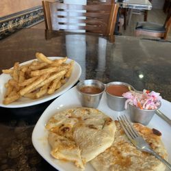 Ranchero Kitchen - Pupusas, with chicken, cheese and jalapeños. Side of fries and a 2oz side of very spicy salsa.