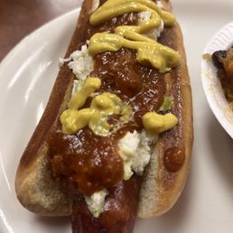 Hot dog with chili, mustard, and slaw Hot dog with chili, mustard, and slaw
