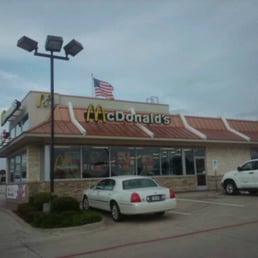 a white car parked in front of a mcdonald's a white car parked in front of a mcdonald's