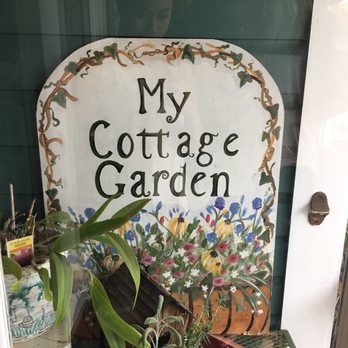 My Cottage Garden - potted plants in front of a sign - Antiques Near Me - Lakeland, Florida My Cottage Garden - potted plants in front of a sign - Antiques Near Me - Lakeland, Florida