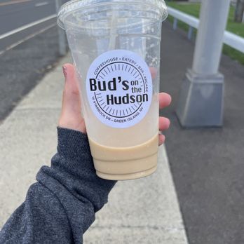 Bud’s On The Hudson - a hand holding a cup of iced coffee - Coffee & Tea Near Me - Green Island, New York Bud’s On The Hudson - a hand holding a cup of iced coffee - Coffee & Tea Near Me - Green Island, New York