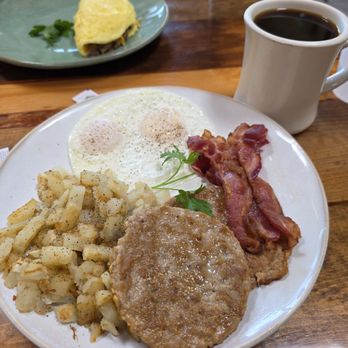 Eddie's Grill - 2 egg breakfast with both sausages and bacon. Barbacoa omelet inn background. - Salad Near Me - Ventura, California