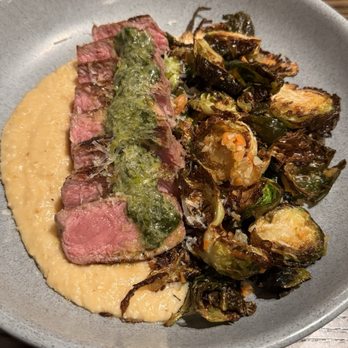 Hendrix - Grass-Fed NY strip with Brussels and grits - Bars Near Me - Columbia, South Carolina Hendrix - Grass-Fed NY strip with Brussels and grits - Bars Near Me - Columbia, South Carolina