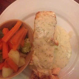 Excellent fresh salmon covered in dill sauce on potatoes.