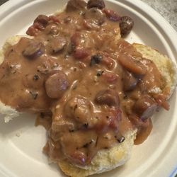 Tomato gravy with conecuh sausage over a biscuit