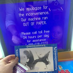 a person holding a ticket for a machine