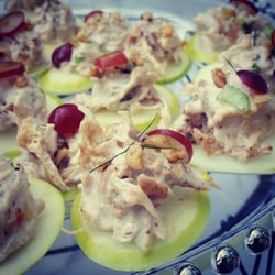 Pogreba Restaurant - Pogy's Charcoal Chicken Salad on a granny smith apple garnished with walnuts and red grapes