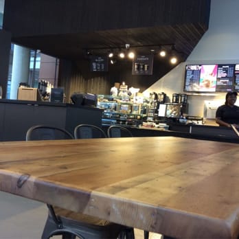 Van Houtte - a woman sitting at a table in a restaurant - Coffee & Tea Near Me - Montreal, Quebec Van Houtte - a woman sitting at a table in a restaurant - Coffee & Tea Near Me - Montreal, Quebec