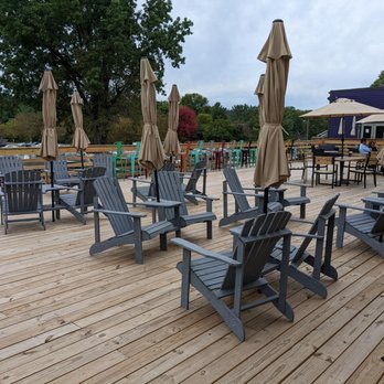 Dead Low Brewing - a deck with chairs and umbrellas - Brewpubs Near Me - Cincinnati, Ohio