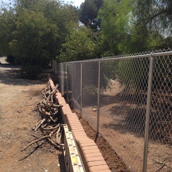 Riverside Fence - End of lot. Extra chain link stitched into the bottom of the fence to account for a dip in the landscape. - Fences & Gates Near Me - Riverside, California