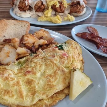 At The Diner - omelet with chicken & biscuits in the background - Breakfast & Brunch Near Me - Orlando, Florida At The Diner - omelet with chicken & biscuits in the background - Breakfast & Brunch Near Me - Orlando, Florida