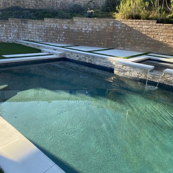 StoneAge Masons - Backyard pool. Masonry work done with artificial turf. Midnight blue tile and beautiful stone. - Masonry/Concrete Near Me StoneAge Masons - Backyard pool. Masonry work done with artificial turf. Midnight blue tile and beautiful stone. - Masonry/Concrete Near Me