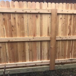 The common share fence with the 2x6 treated footer to prevent the deterioration of the bottom of the cedar wood pickets. A closer view.