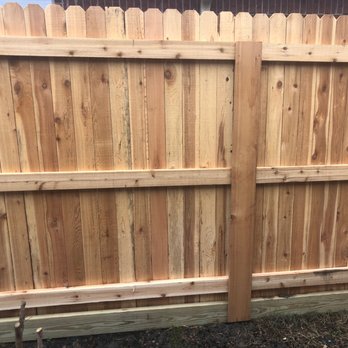 DFW Fence Contractor - The common share fence with the 2x6 treated footer to prevent the deterioration of the bottom of the cedar wood pickets. A closer view. - Fences & Gates Near Me - Fort Worth, Texas